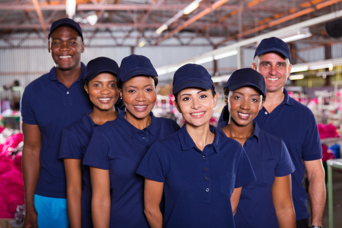group of happy clothing factory workers